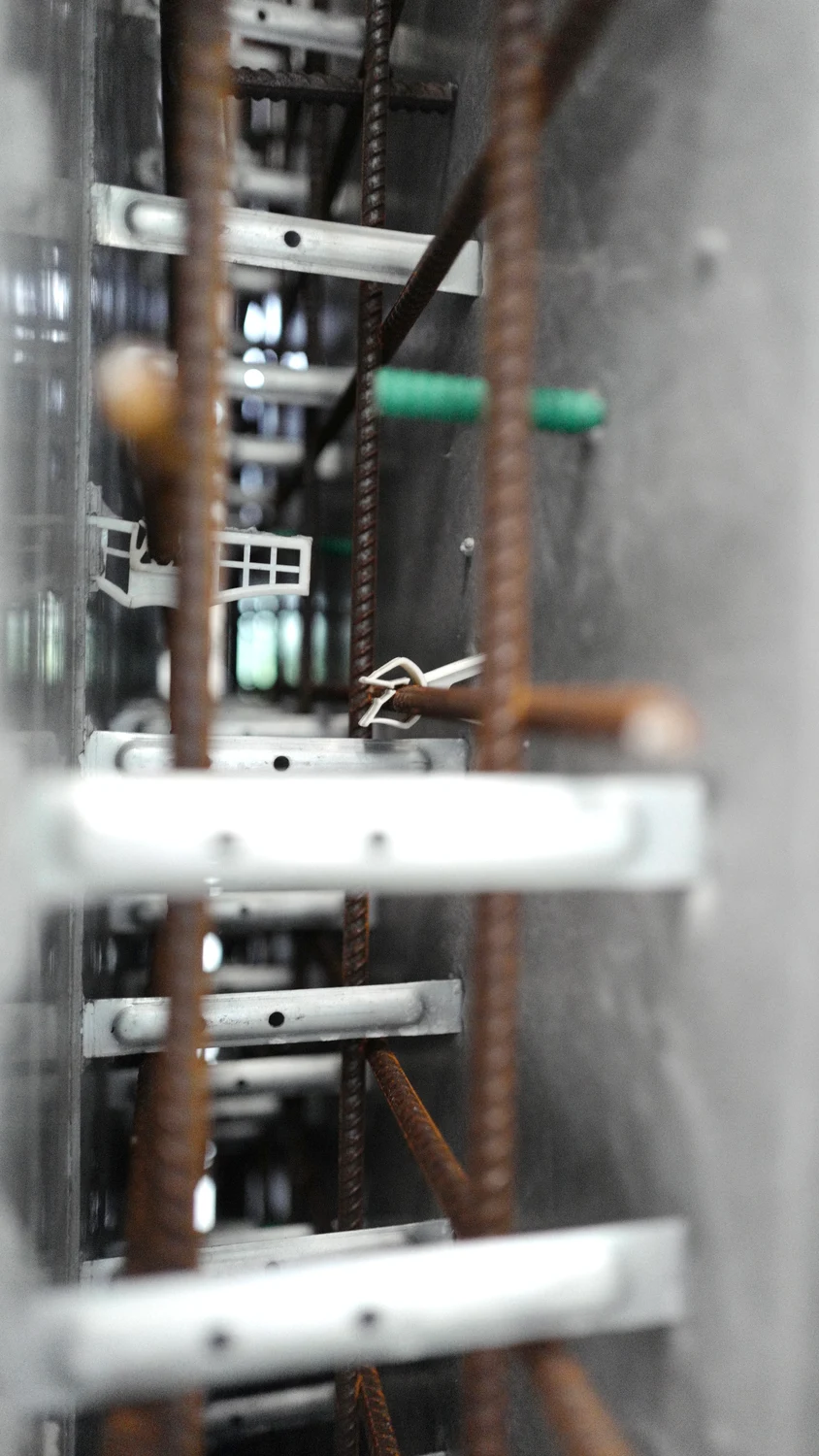 Rebar spacers holding the cage at concrete cover